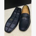 Prada black Pebbled Leather Loafers featuring a brand signature logo on gunmetal-tone hardware.