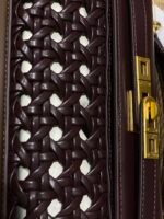 JW PEI Noor Top Handle Bag in dark red is a vegan leather bag featuring gold hardware and a woven design. - Image 3