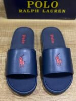 Polo Ralph Lauren Cayson Slides in a classic navy blue and red colorway. These lightweight pool slides are crafted with a synthetic leather upper strap lined with soft, cushioned fabric for comfortable wear. - Image 2