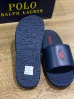 Polo Ralph Lauren Cayson Slides in a classic navy blue and red colorway. These lightweight pool slides are crafted with a synthetic leather upper strap lined with soft, cushioned fabric for comfortable wear. - Image 4